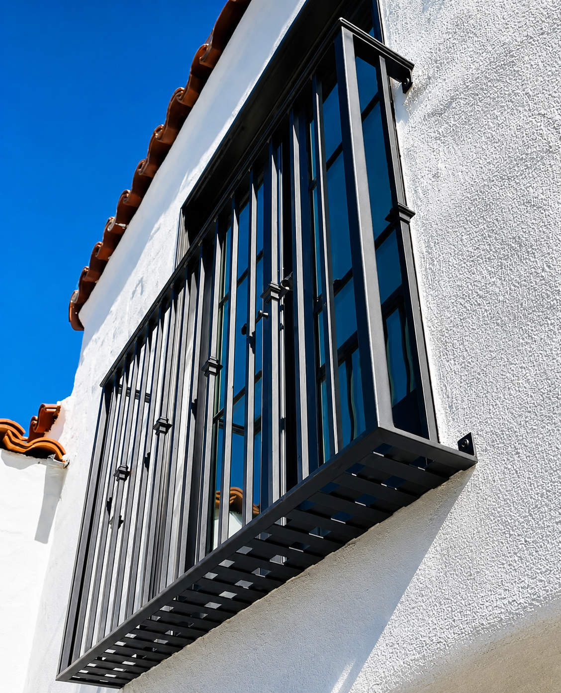 Black Juliet balcony guard on white stucco wall