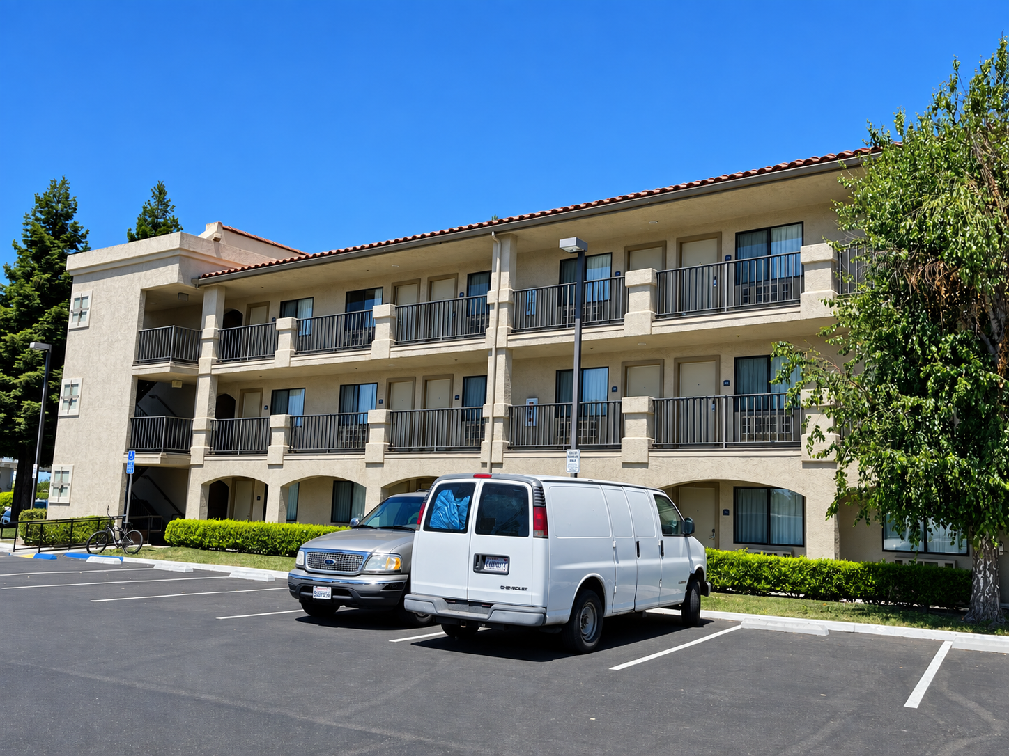 Commercial hotel building with black railings across multiple floors