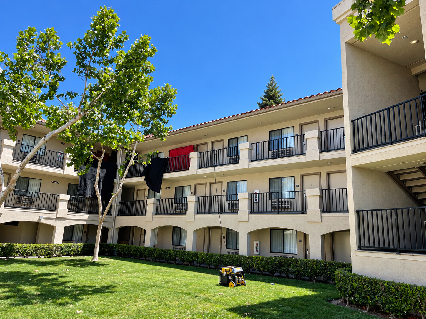Commercial courtyard view with black railings on hotel balconies
