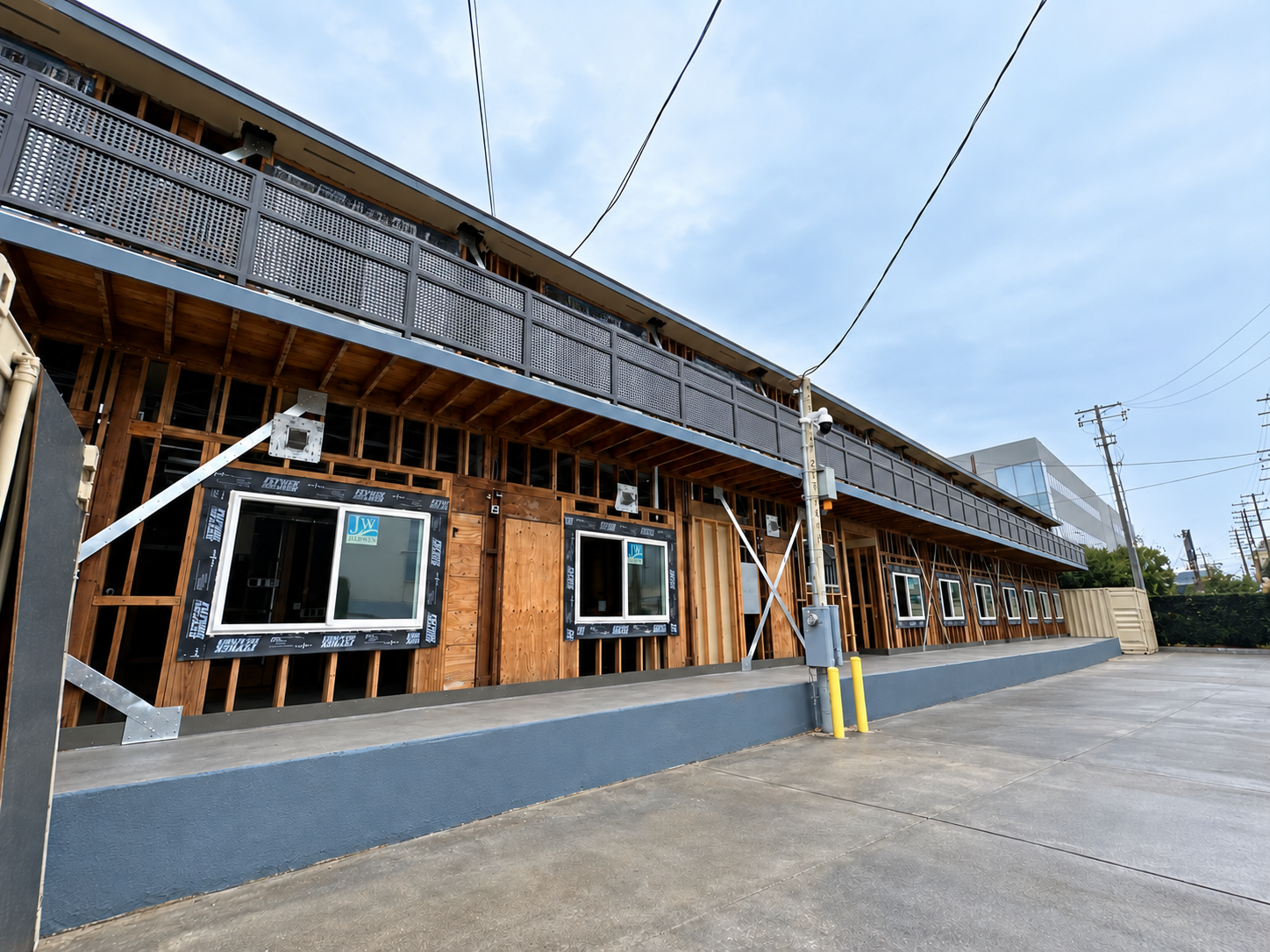 Commercial building under renovation with perforated metal balcony railing