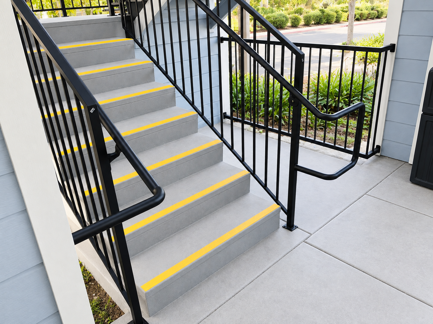 Commercial stair railing detail beside landscaped walkway