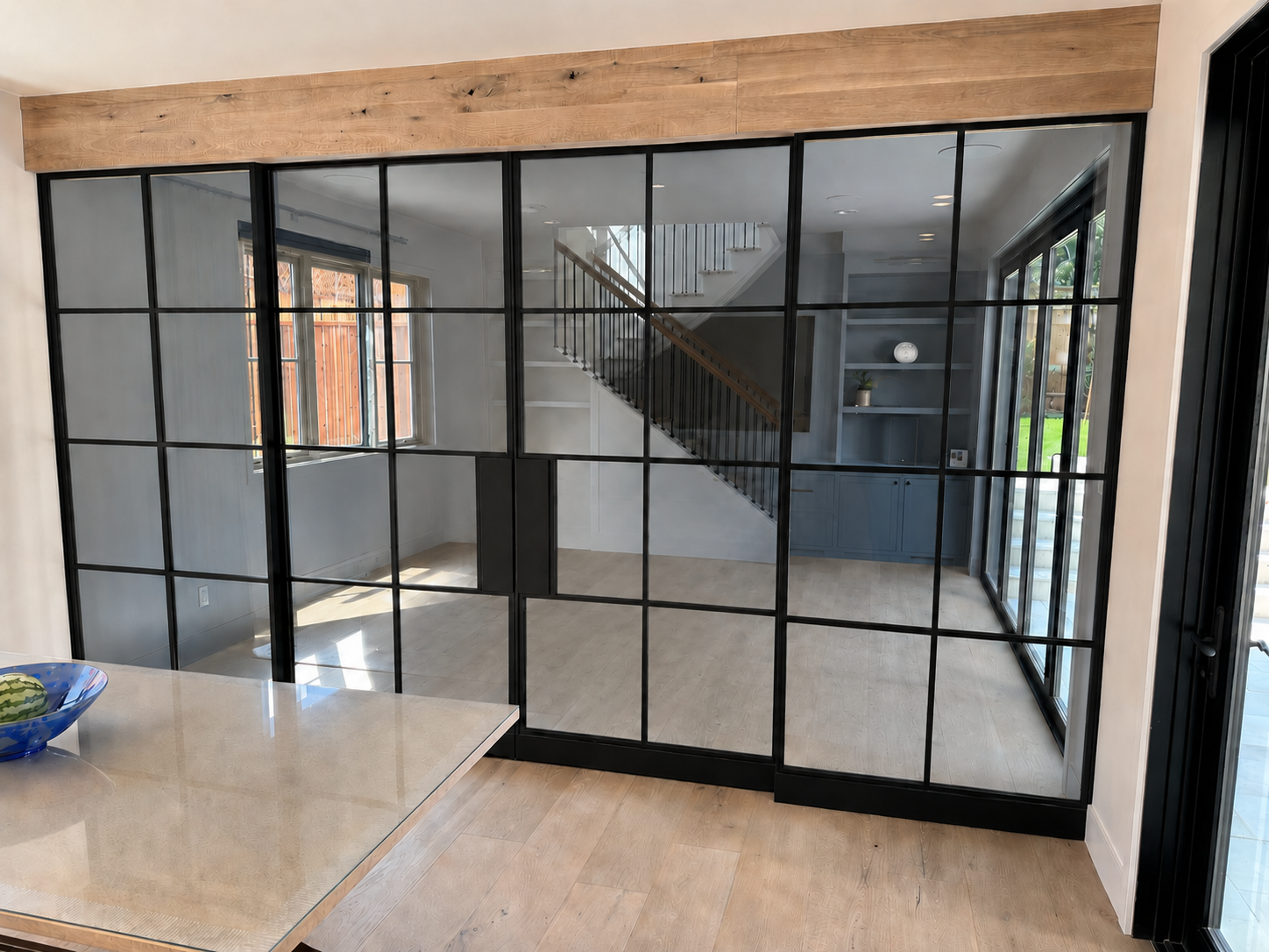 Black metal and glass interior partition doors viewed from kitchen