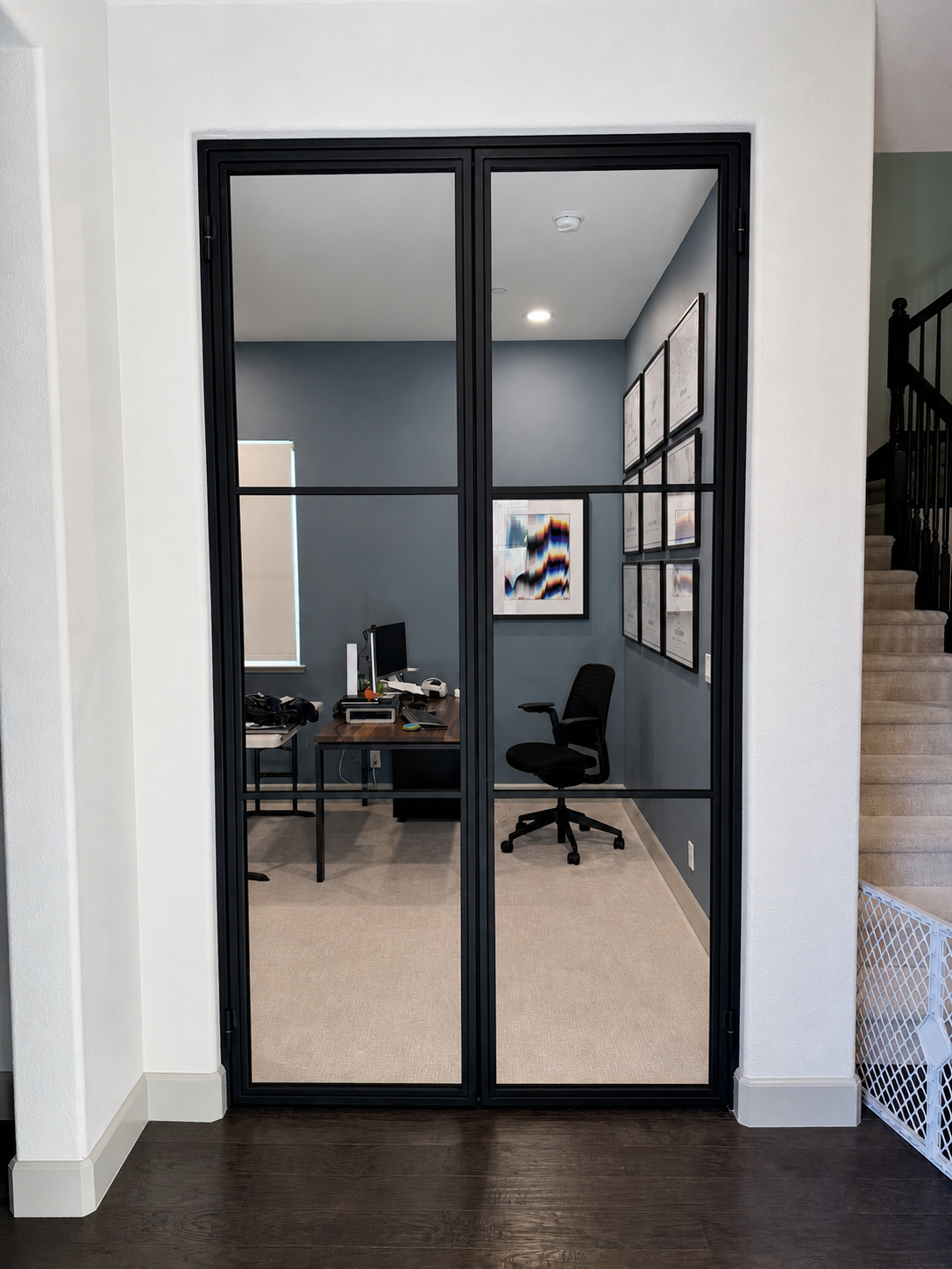 Closed black glass office doors with metal frame