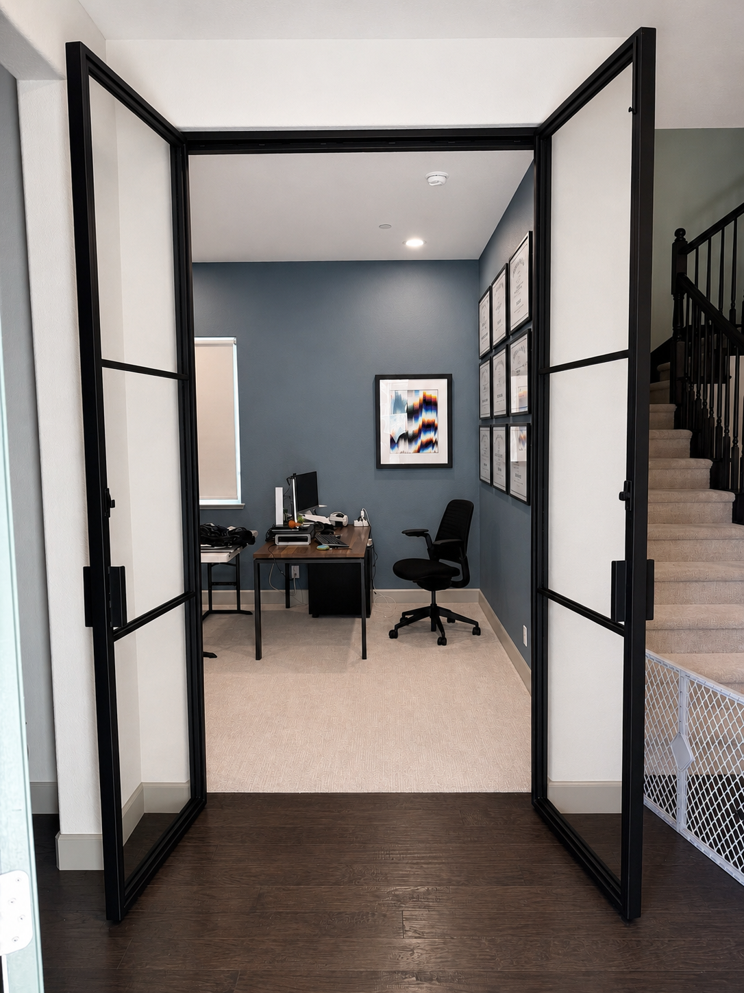 Open black glass office doors with metal frame