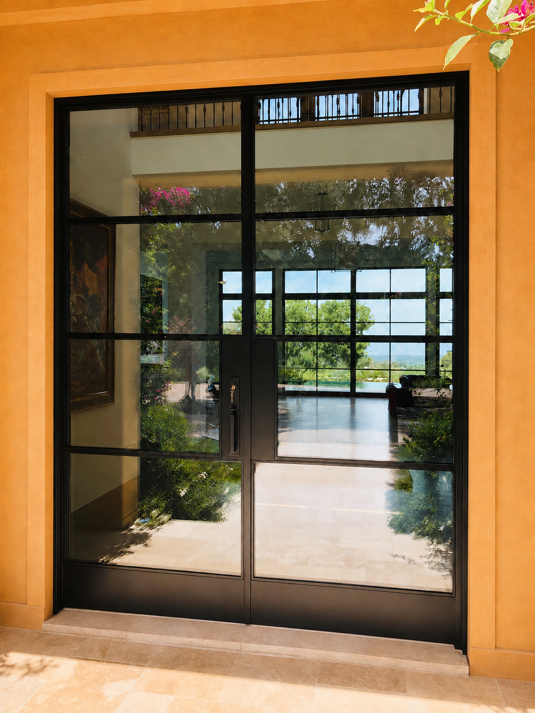 Close view of black metal and glass entry door with reflected interior