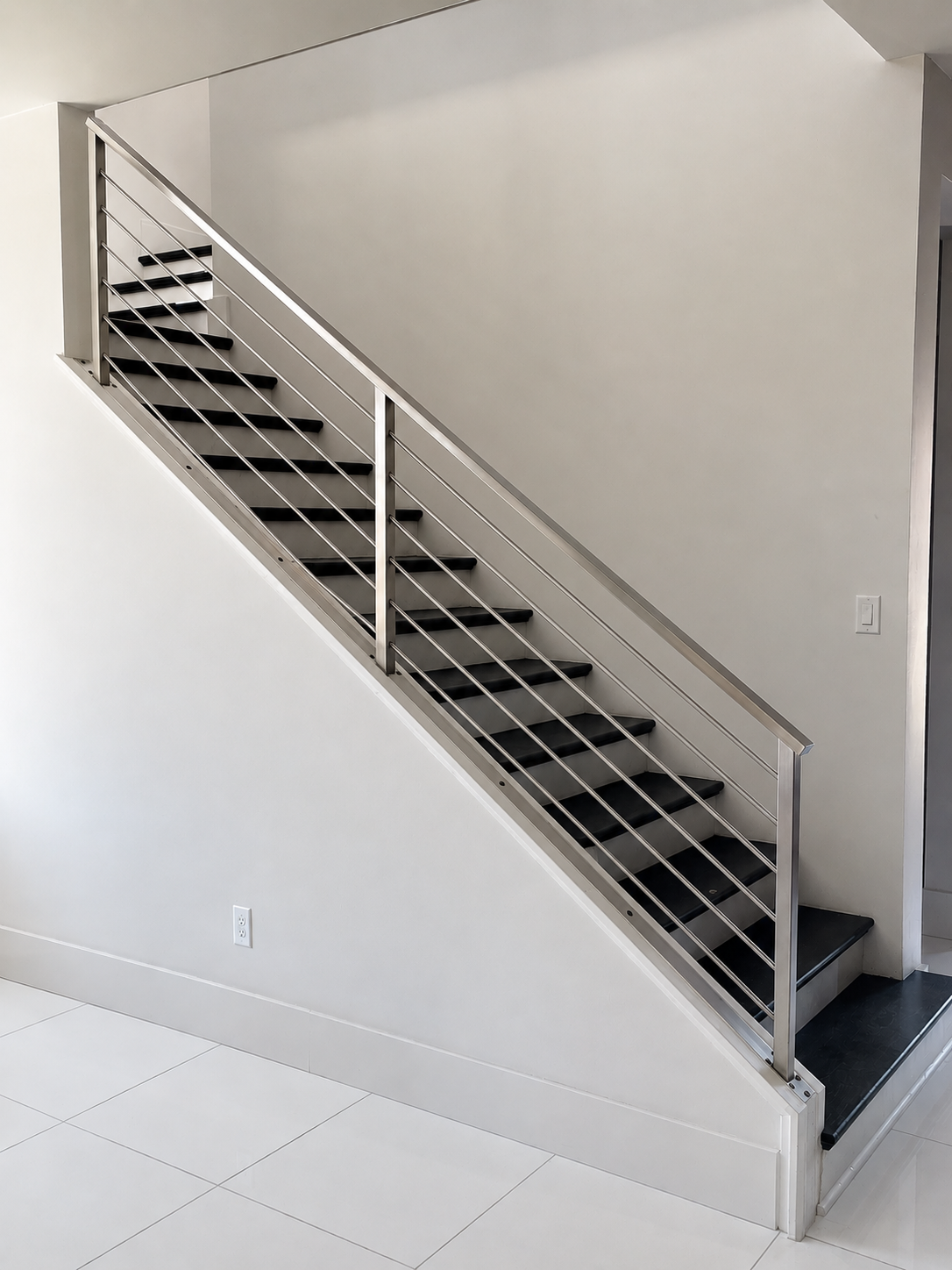 Stainless steel stair railing with black stair treads