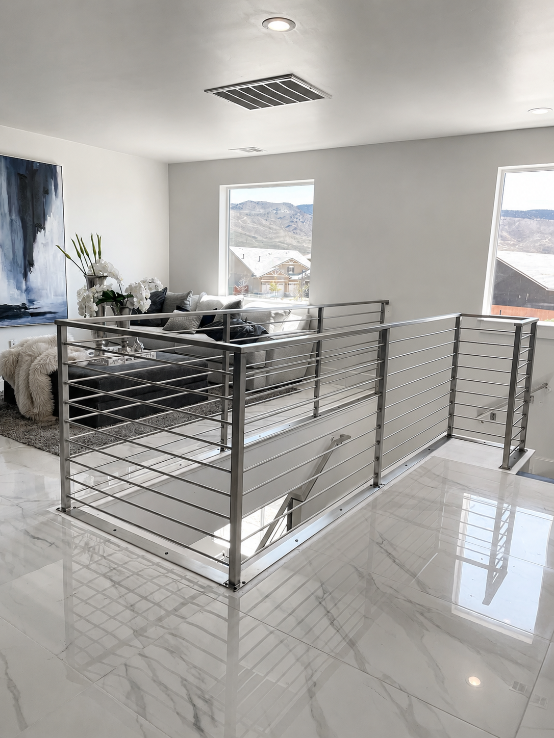 Stainless steel railing around open stairwell