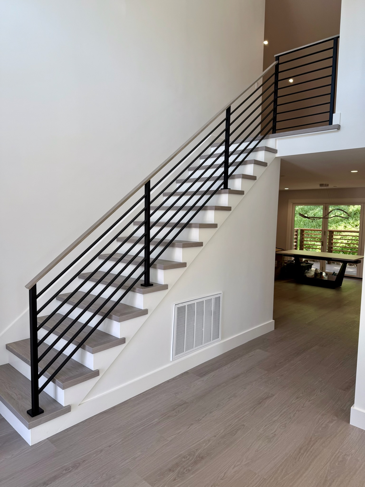 Black interior stair railing with horizontal bars