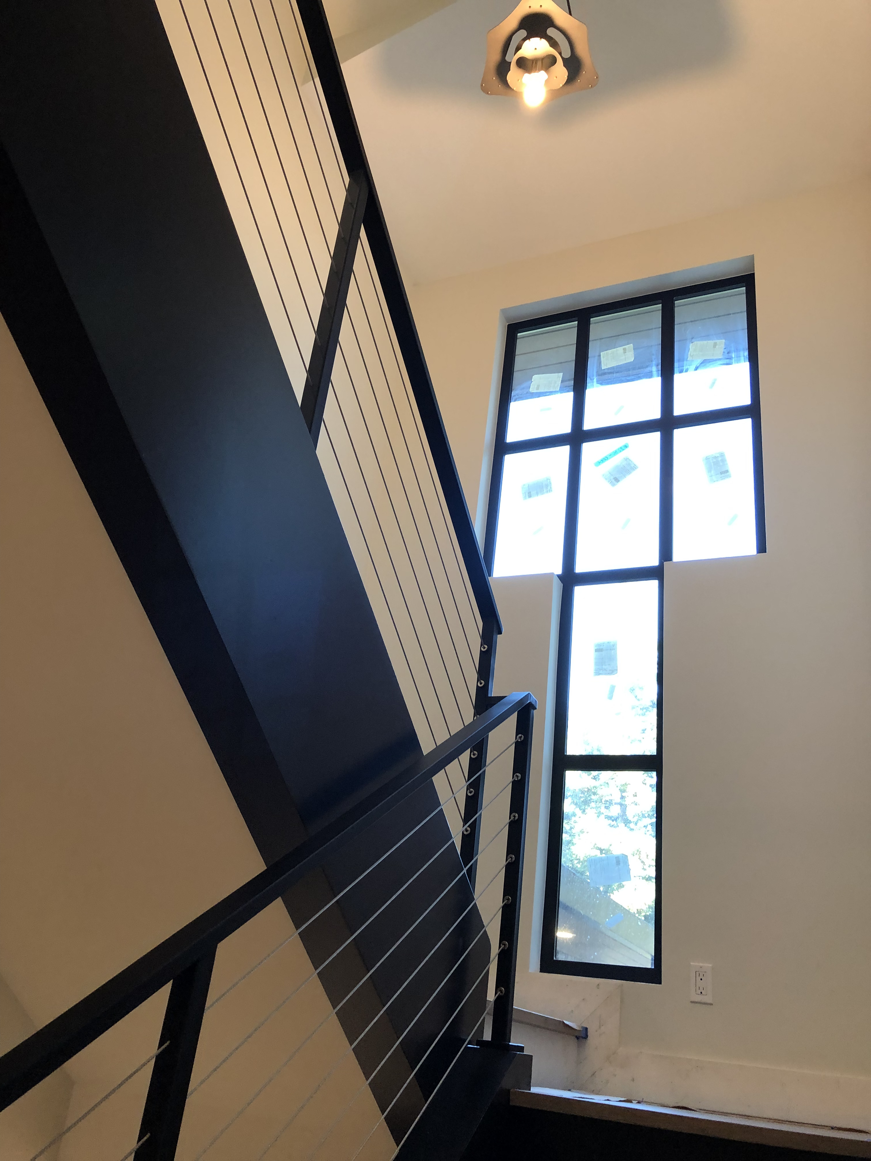 Cable railing detail beneath pendant light