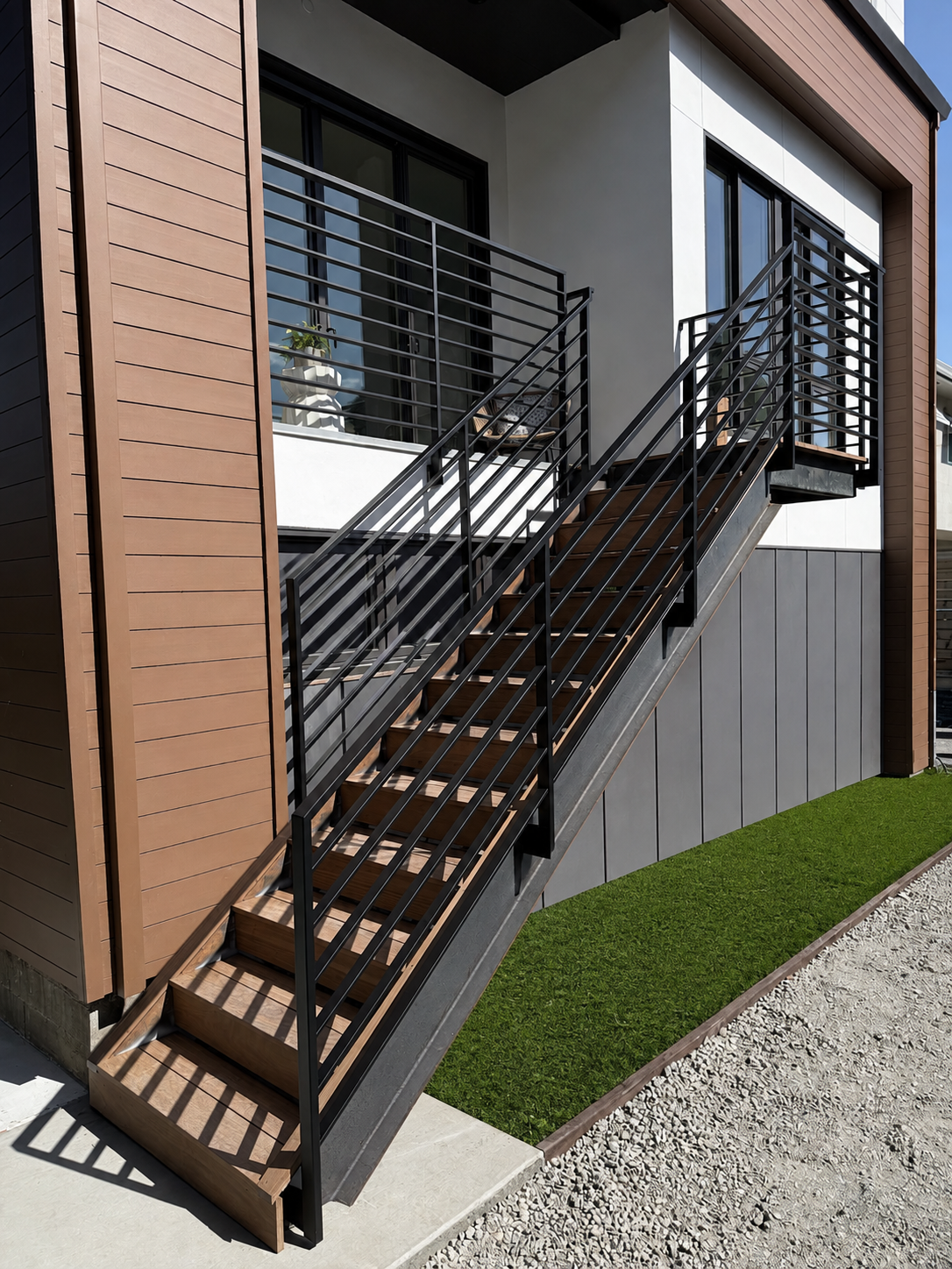 Black stair railing with wood steps on modern exterior