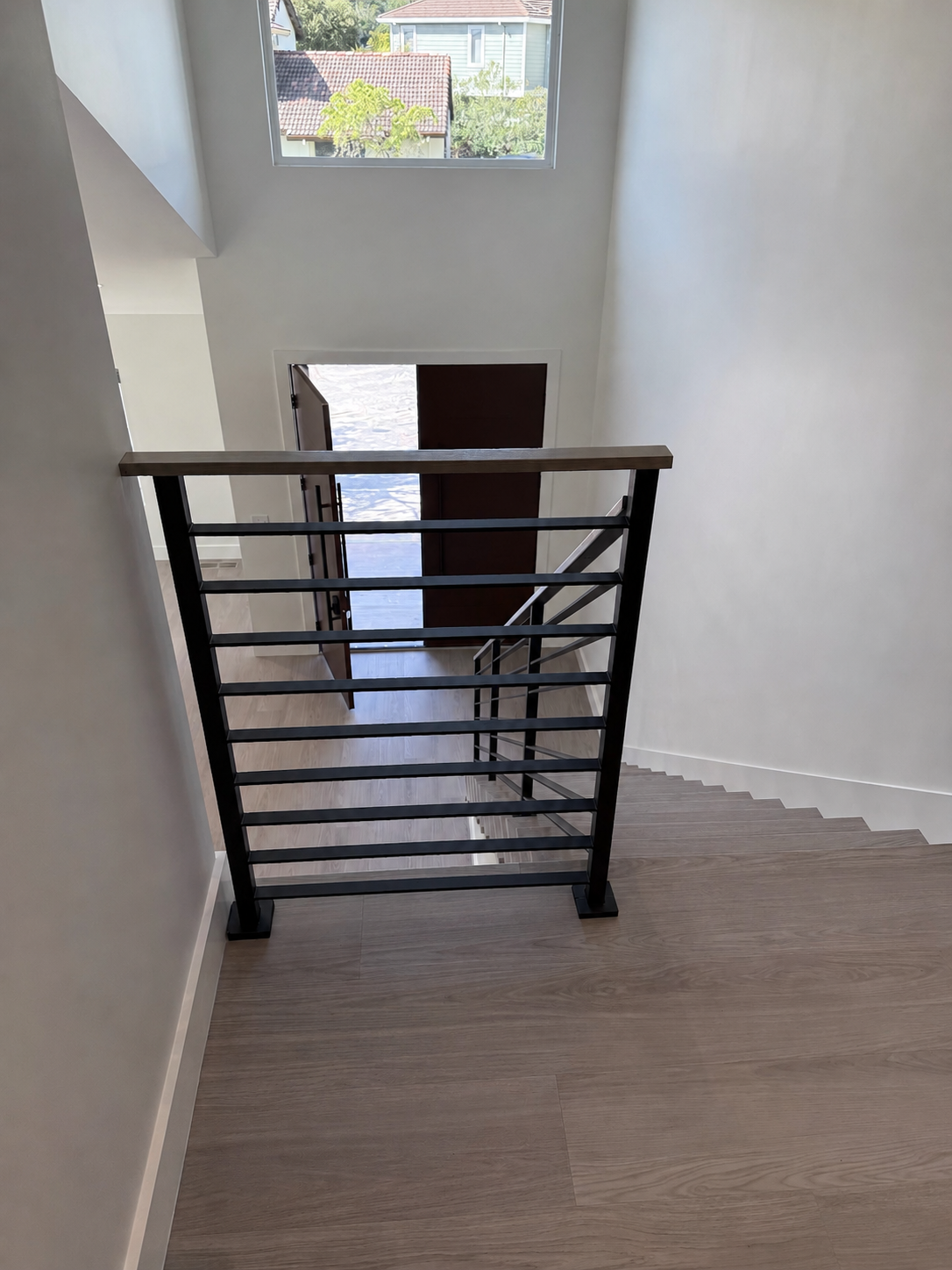 Upper landing railing with black horizontal bars