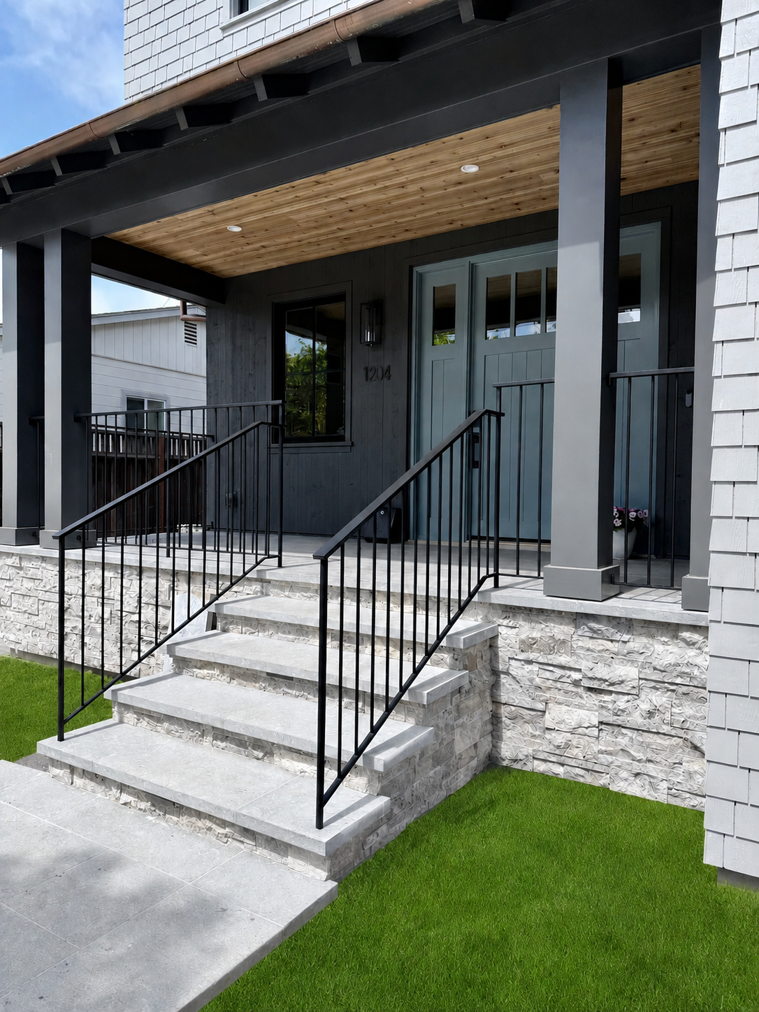 Black exterior entry stair railing on front porch