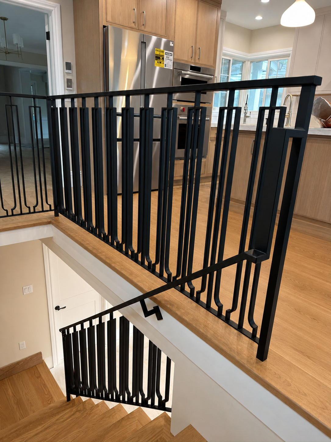 Black interior railing beside kitchen and stair opening
