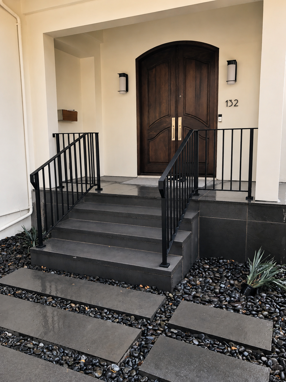 Black entry stair railing with wood double door