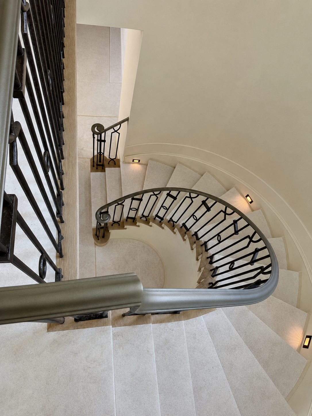 Interior curved stair railing viewed from above