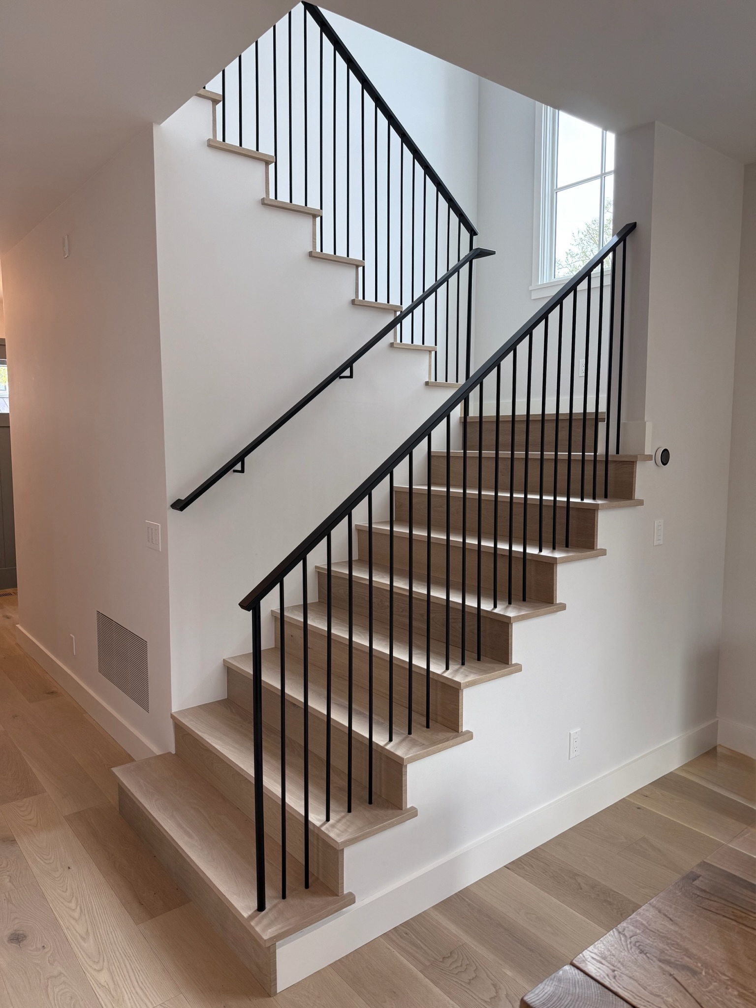 Modern interior staircase with black metal railing