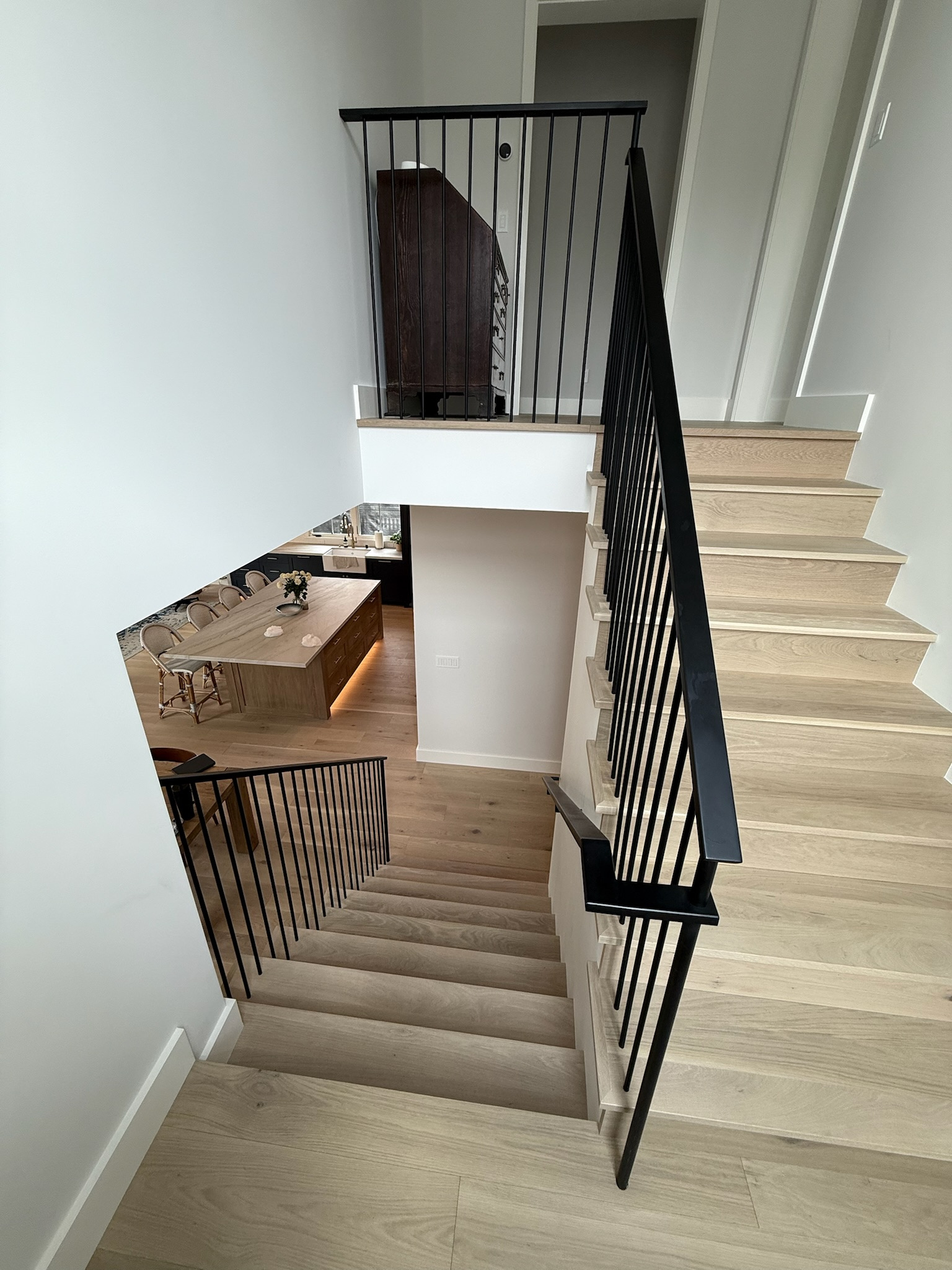Upper view of modern black stair railing and wood staircase