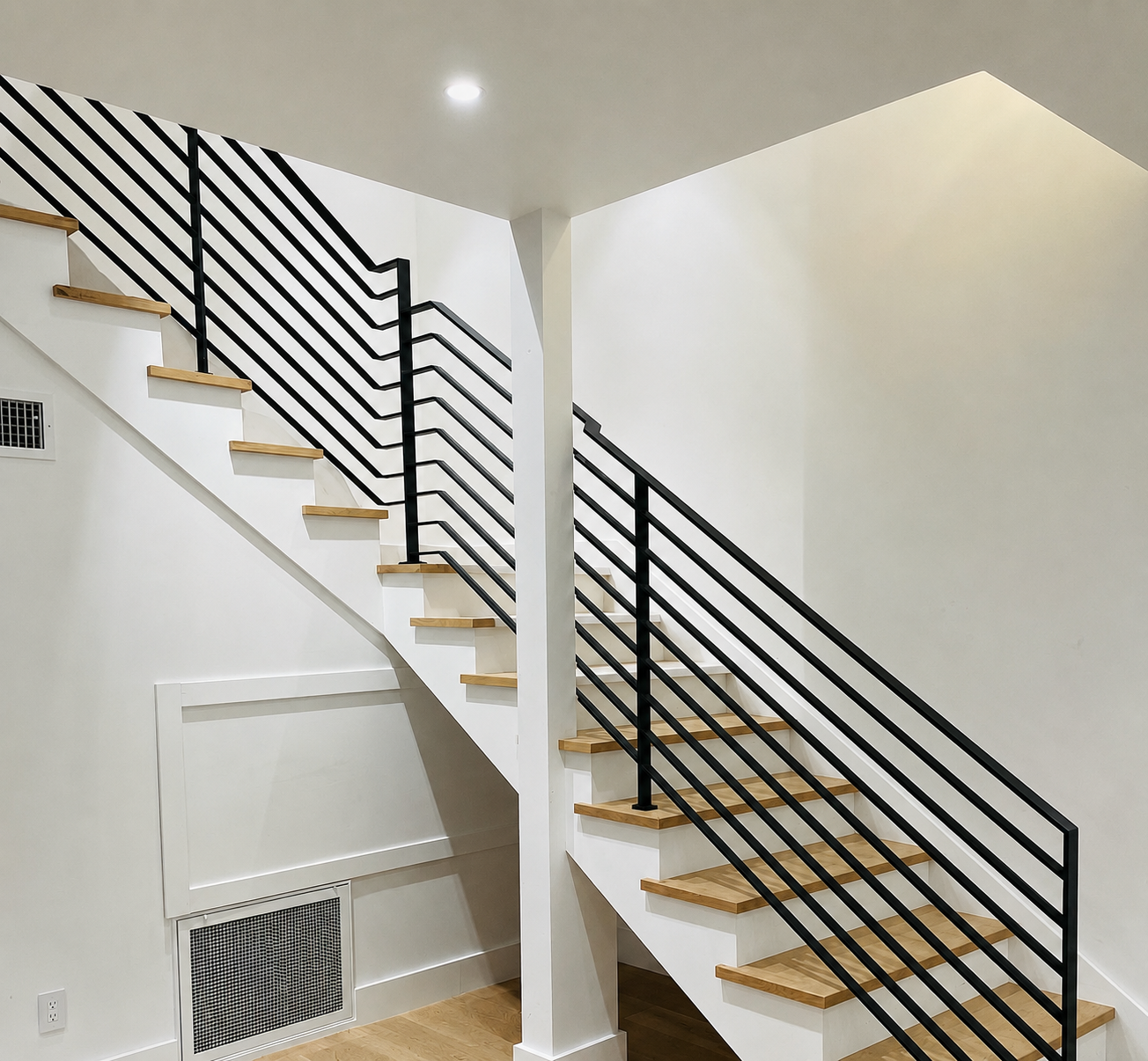 Black horizontal stair railing with wood treads