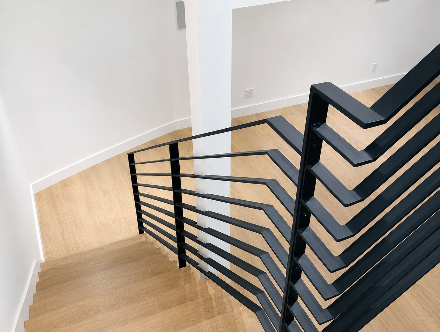 Upper landing detail of black horizontal stair railing