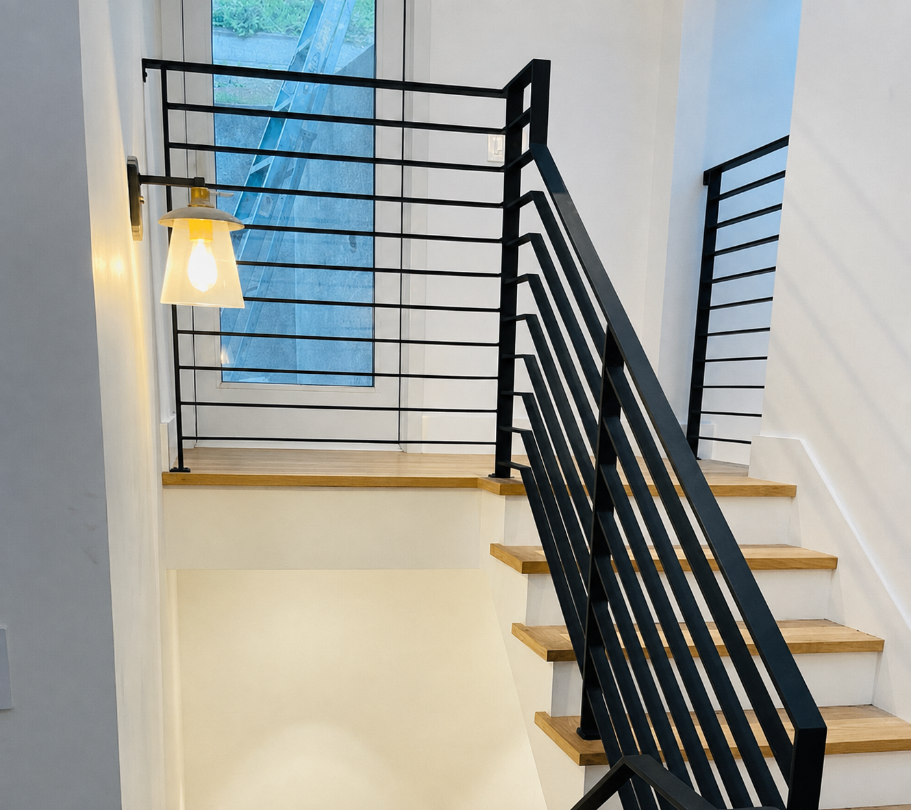 Black stair railing with horizontal guardrail and wood treads