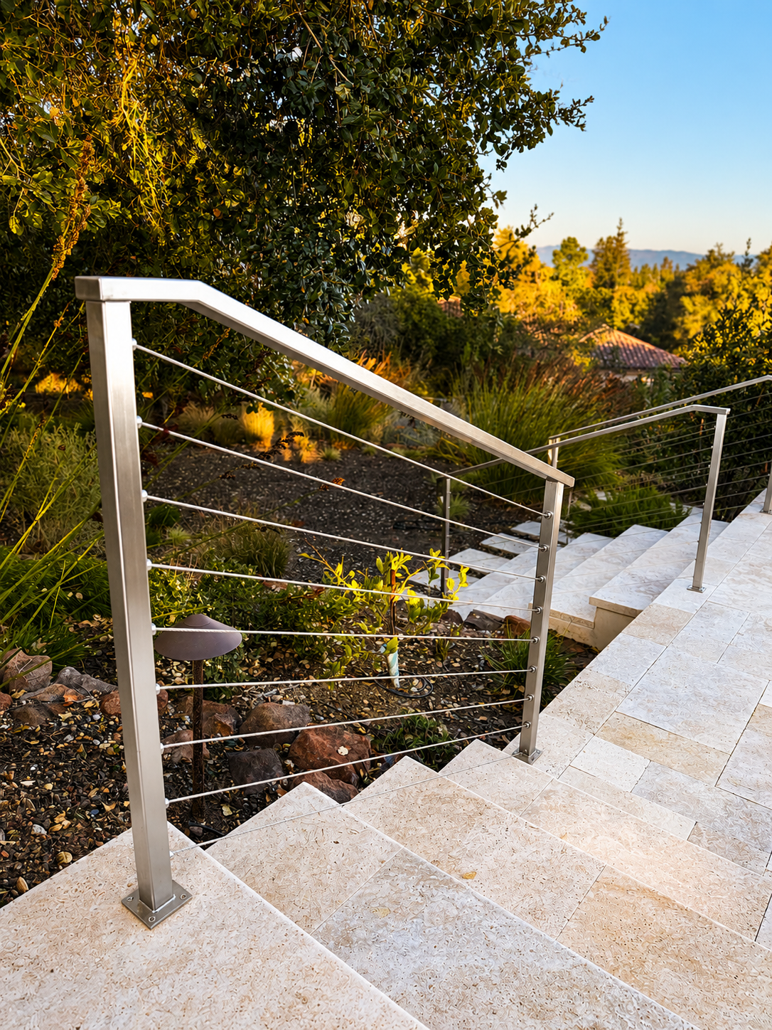 Stainless steel cable railing on outdoor stone steps