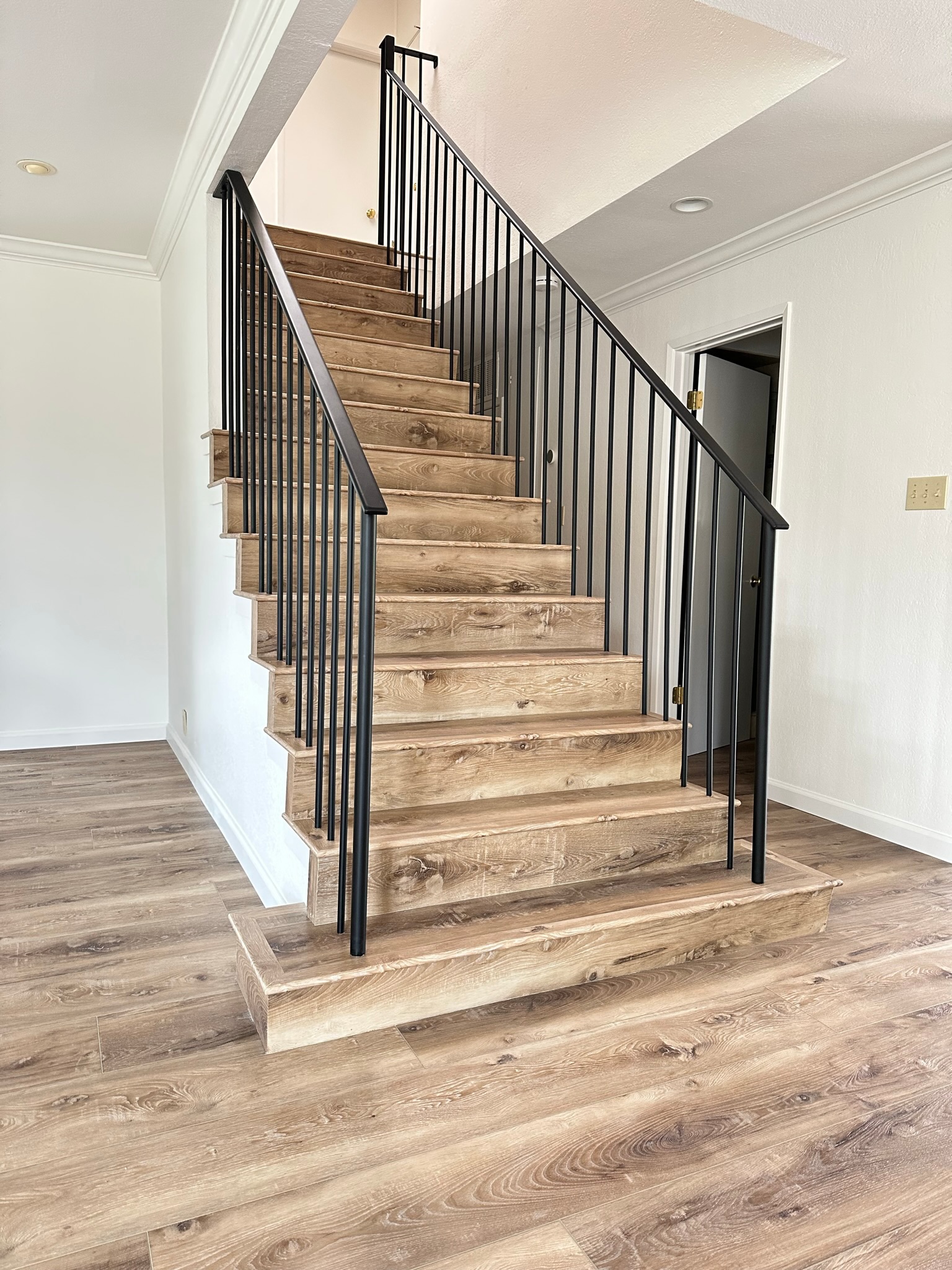 Black interior stair railing with wood steps