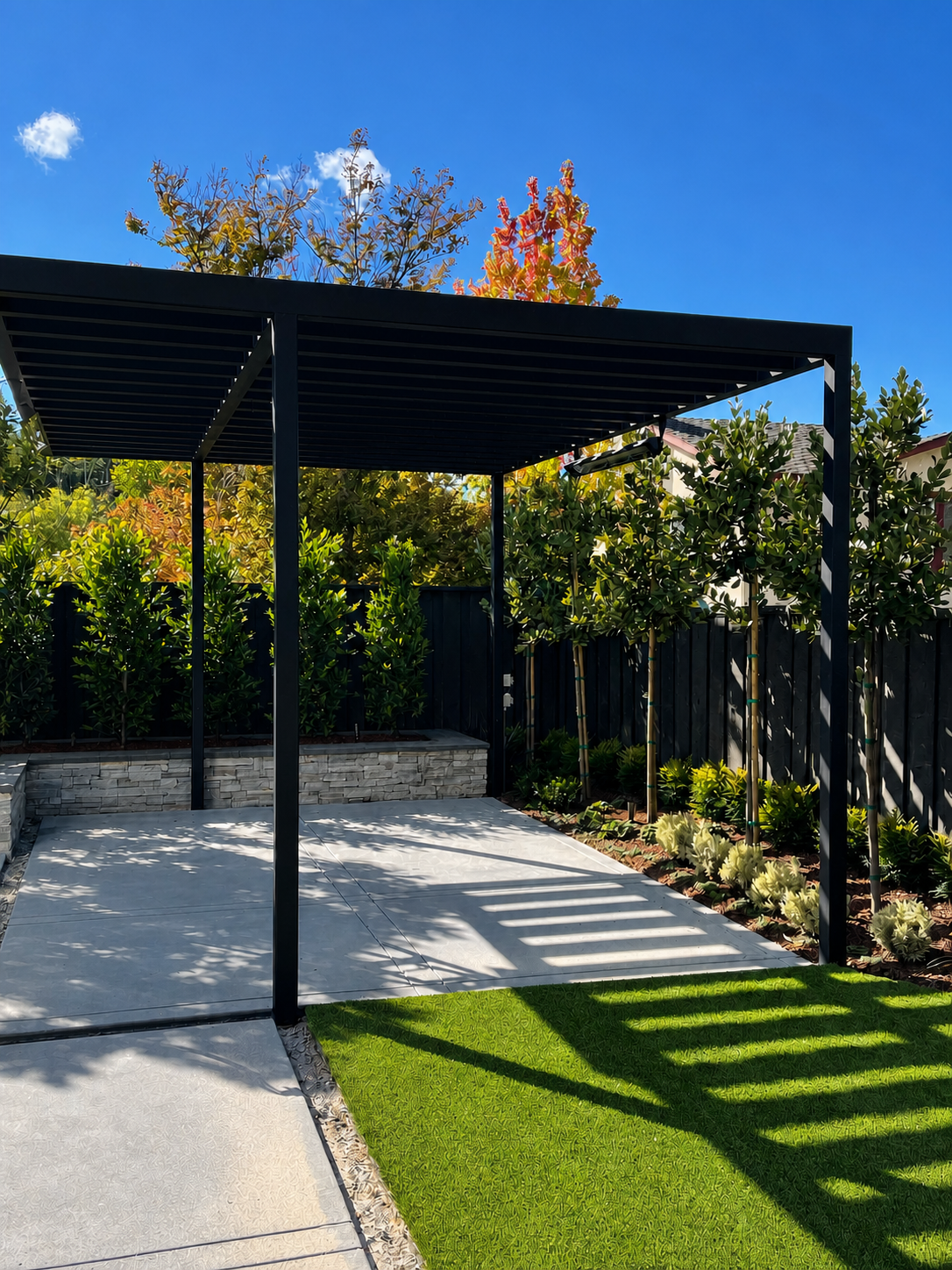 Clean black metal trellis over patio and garden