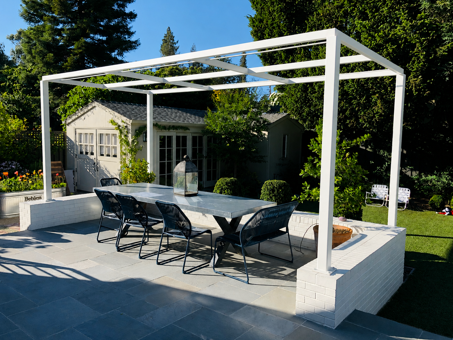 White metal trellis over patio dining area with garden seating